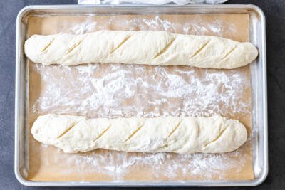 Two baguettes on a baking sheet