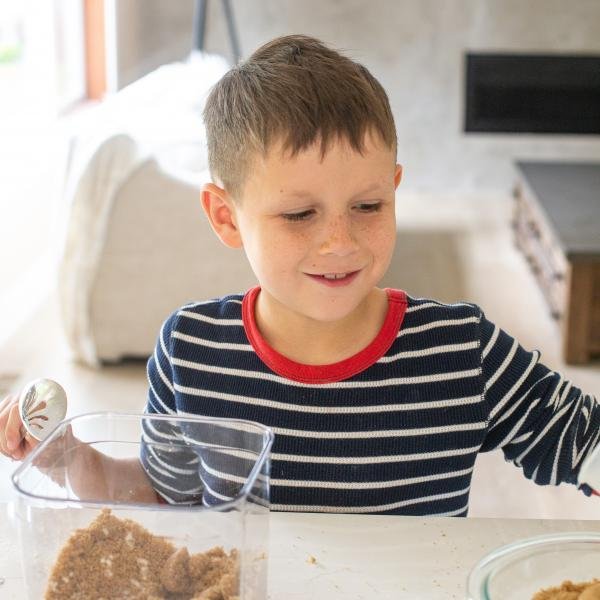 Ethan measuring brown sugar for chocolate chip cookies