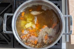 Chicken Noodle soup in a pot with potatoes and corrots
