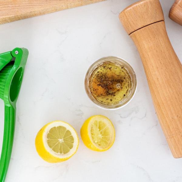 Avocado salad dressing in the making, jar, lemon and salt, pepper