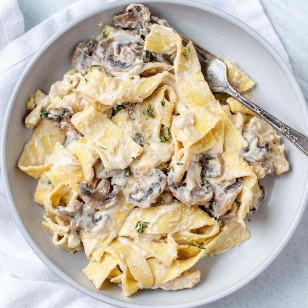 Mushroom Fettuccine Alfredo in a plate with a fork