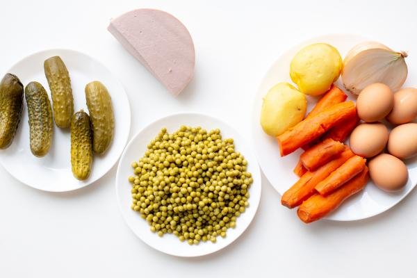 Olivier Salad ingredients on a cutting board