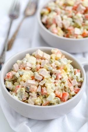 Russian Salad in a bowl, another bowl in background