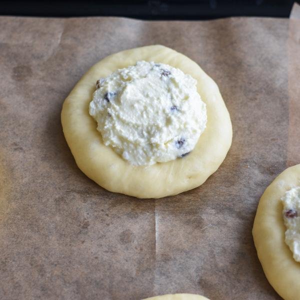 Vatrushka dough with a filling on a tray