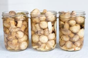 3 jars filled with mushrooms and liquid