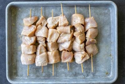 Chicken skewers on a baking sheet