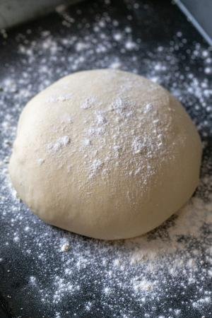 Pizza dough on a floured surface