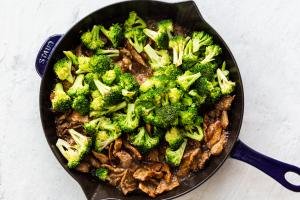pan with beef and fresh broccoli just added