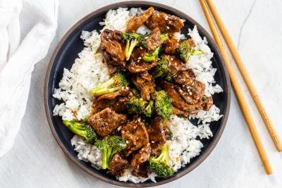 Beef and broccoli over rice in a plate