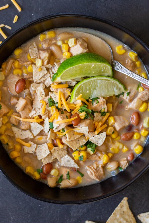 White Chicken Chili in a bowl with lime and chips