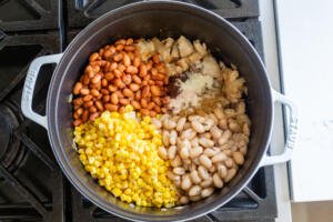Beans and corn added to the pot with seasoning