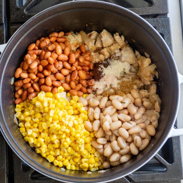 Beans and corn added to the pot with seasoning