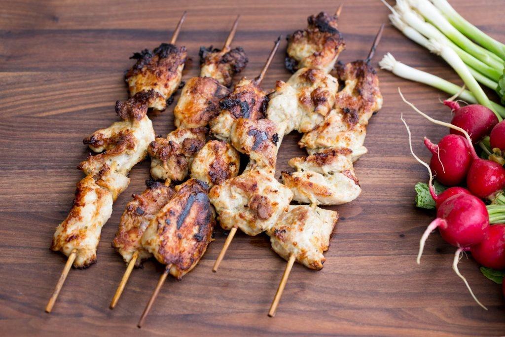 Grilled chicken kabobs on a cutting board