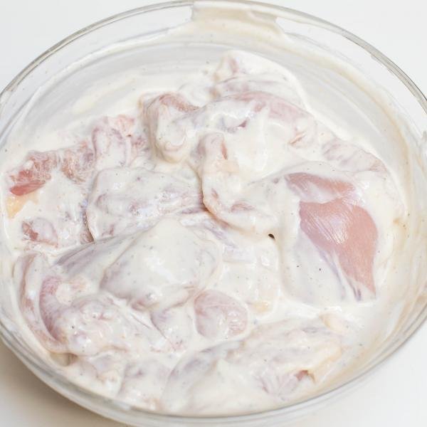 Chicken in a marinade in a bowl