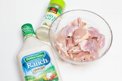 Chicken, seasoning and ranch on a board