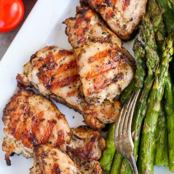 Grilled chicken on a plate with asparagus