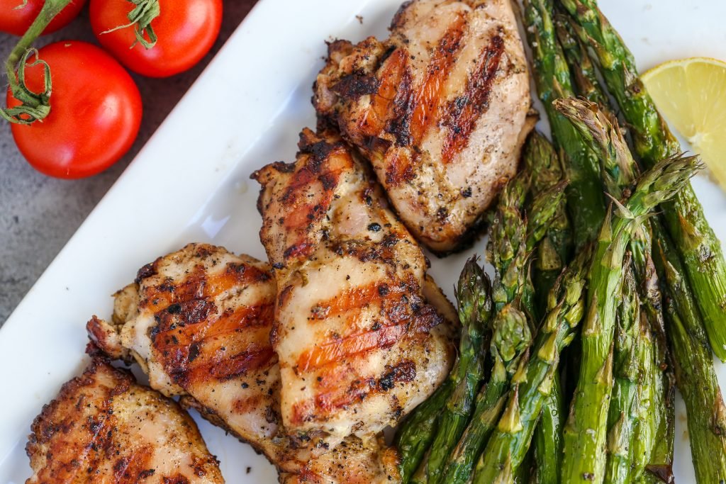Grilled chicken with asparagus on a plate