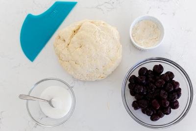 Dough with cherries, sugar and flour