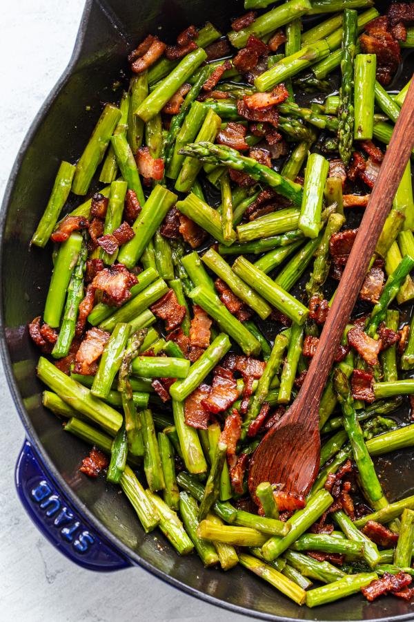 asparagus and bacon in a frying pan 