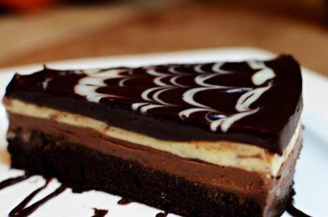 A slice of black tie mousse cake on a plate