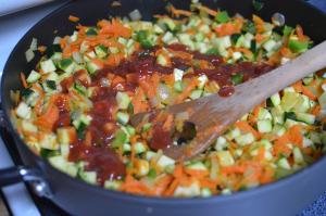 Vegetables in a skillet with ketchup
