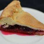 A slice of plum pie on a plate