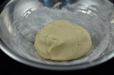 Dough mixed into a ball in a bowl