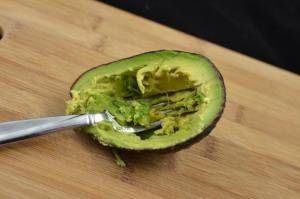 Mashing avocado with a fork