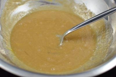 A mixture of applesauce, sugar, eggs, vanilla and honey in a bowl