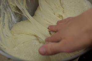Dough being folded away from side of the bowl