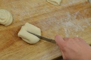 Each Moscow bun being cut in the center on a cutting board
