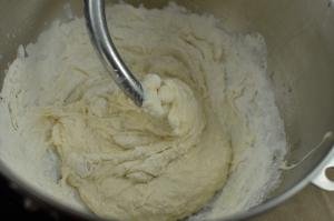 Mixing in more flour with the dough in a KitchenAid