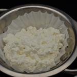 A strainer lined with a coffee filter filled with cottage cheese