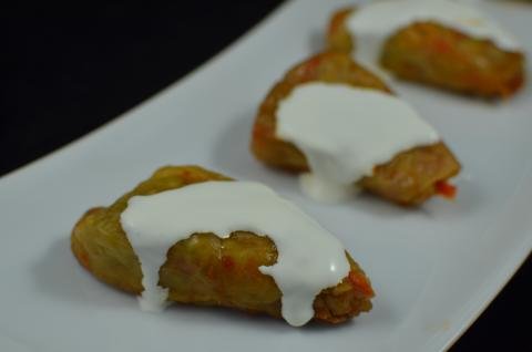 Cabbage Rolls with sour cream on top on a plate