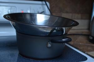 Pot with bowl on top on a stove top