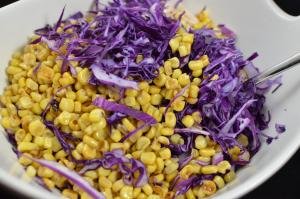 Corn, red cabbage and chicken slices in a bowl