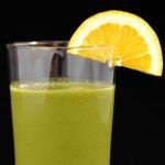 Green Smoothie with a orange slice on the brim of the glass