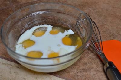 Eggs, milk and salt in a bowl being whisked together
