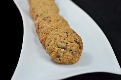 A row of oatmeal raisin cookies on a plate