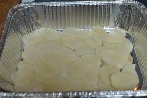 Sliced potatoes on a baking sheet