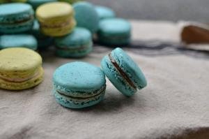 A pile of green and blue macarons
