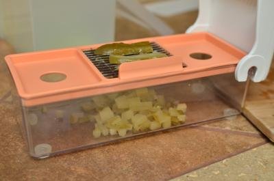 Pickles being diced using a plastic dicing machine