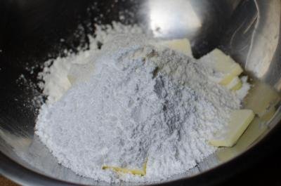 A combination of flour, sugar, and butter in a food processor
