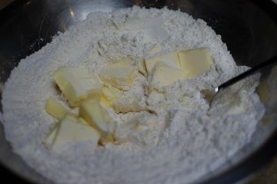 A mixture of butter, flour, and yeast in a bowl