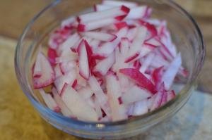 In a bowl radishes chopped into long thin strips