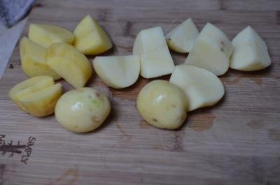 Potatoes peeled and cut into equal pieces on a cutting board