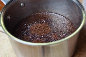 Ground coffee combined with water in a large pot
