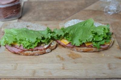 Each side of bread layered with meat, cheese and lettuce