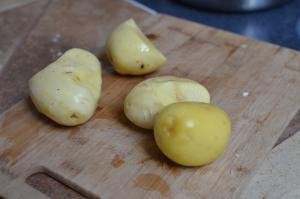 Peeled and clean potatoes on a cutting board