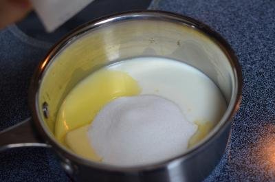 Milk, margarine, and sugar in a saucepan on a stove top